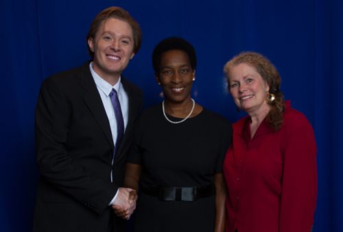 Loretta with Clay Aiken and a woman in red against a blue backdrop
