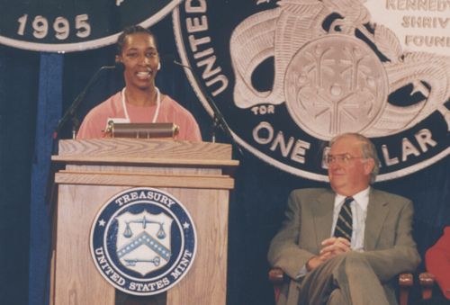 Loretta speaking at a 1995 U.S. Mint event as Lowell Weicker looks on