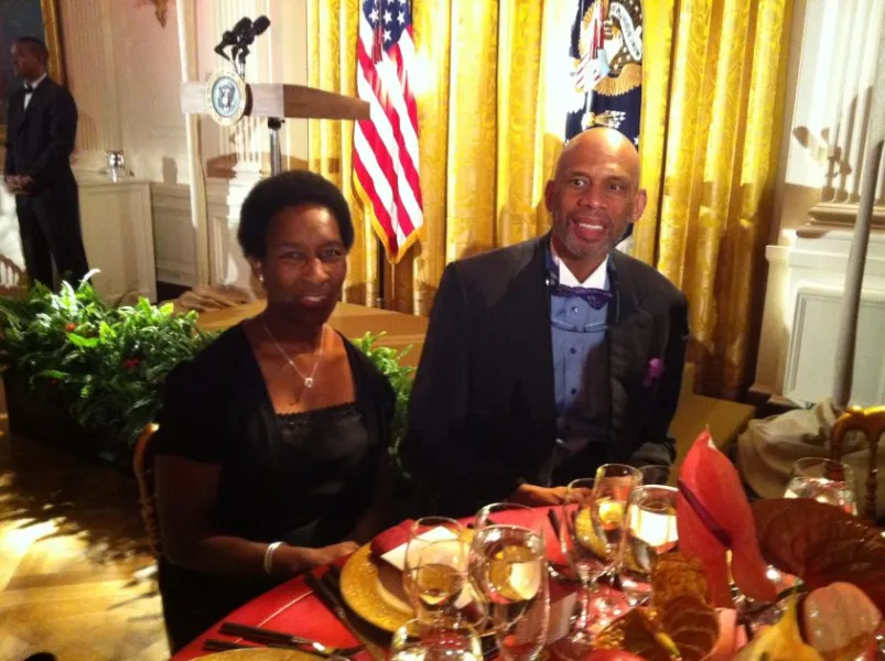 Loretta and Kareem Abdul-Jabbar seated together at a formal dinner