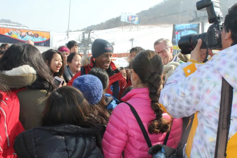 Loretta surrounded by a crowd and photographers at a snowy winter event